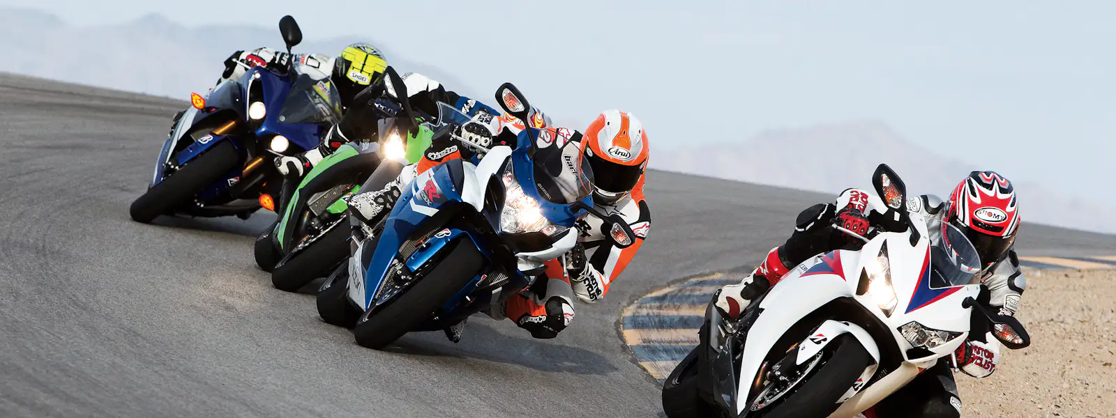 Four riders cranked over through a corner